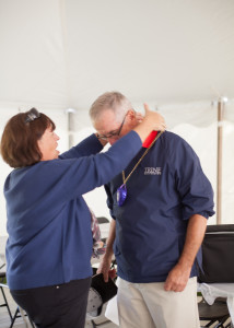 Jane Anderson places Alpha Sig purple heart on husband, Tux #864, for wounded arm sustained in GDI war of 1972